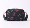 CAMERA-CHERRY-BLUE | Cherry Camera Crossbody Bag On Blue Backdrop