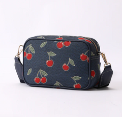 CAMERA-CHERRY-BLUE | Cherry Camera Crossbody Bag On Blue Backdrop
